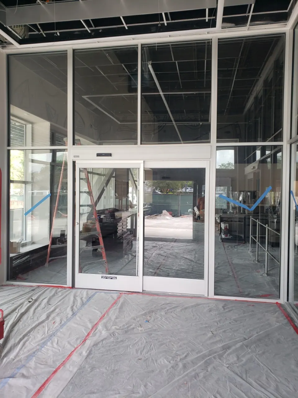 Aluminum-framed automatic glass entrance inside a commercial building