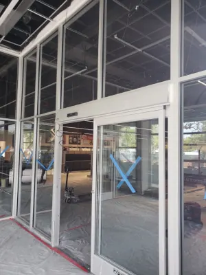 Automatic sliding glass doors set within a commercial aluminum storefront