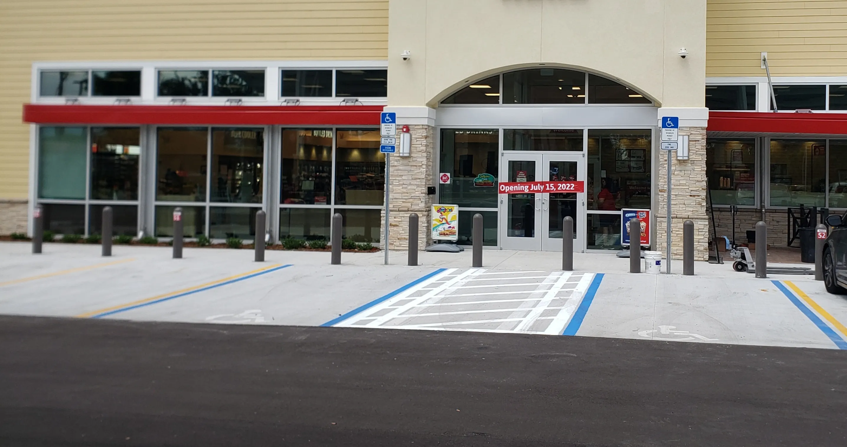 Completed commercial storefront with aluminum-framed windows and glass entrance doors