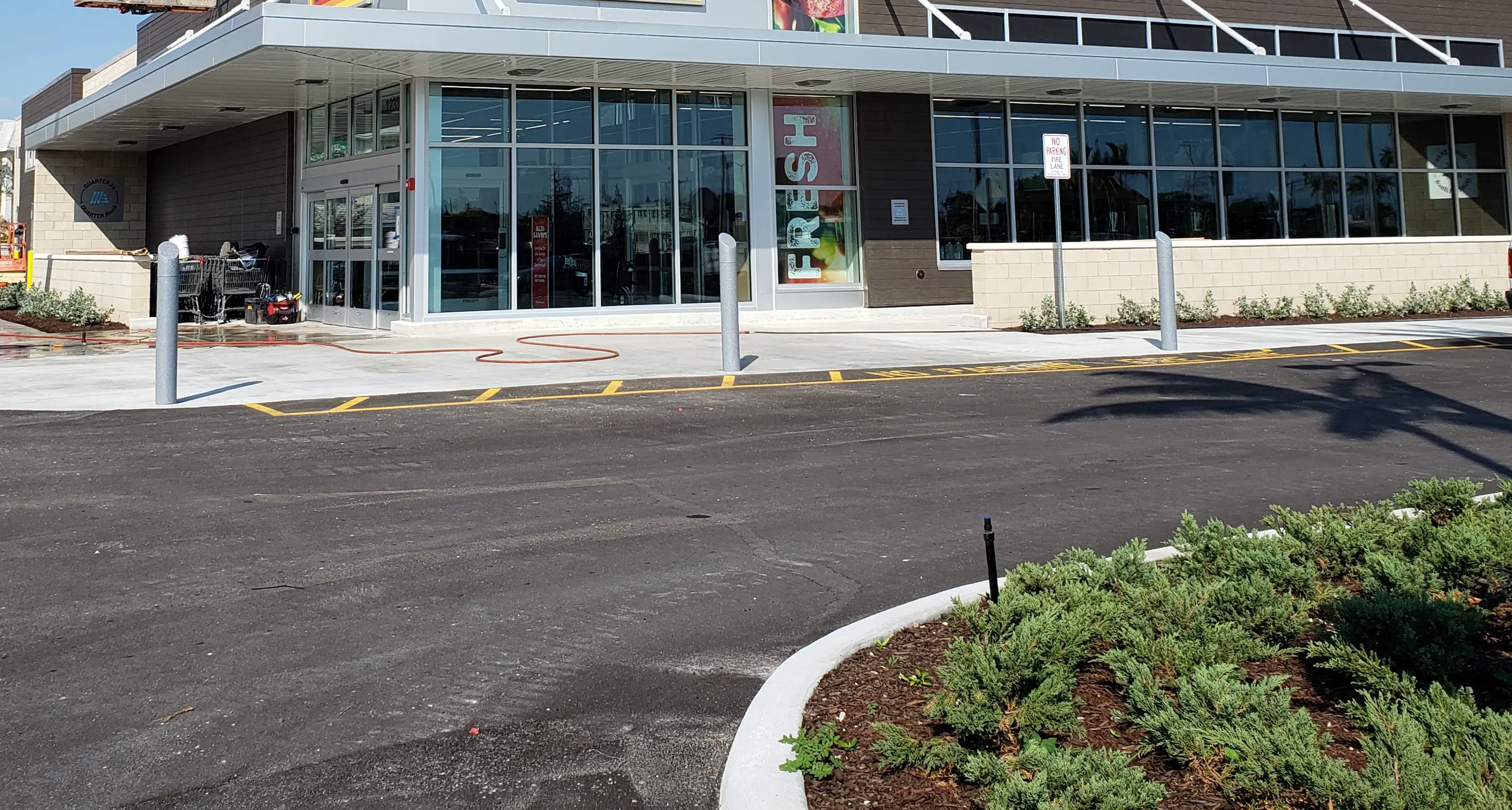 Completed commercial window wall wrapping a building entrance